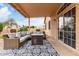 Covered patio featuring an outdoor seating area with string lights, with desert landscaping beyond at 11163 E Laurel Ln, Scottsdale, AZ 85259