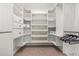 Spacious walk-in closet featuring custom shelving and drawers at 11163 E Laurel Ln, Scottsdale, AZ 85259