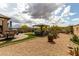 Beautifully landscaped backyard with gazebo, desert plants, and dining area with brick patio at 11571 E Chevelon Trl, Gold Canyon, AZ 85118