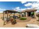 Expansive backyard with desert landscaping, gazebo, patio, and outdoor dining area at 11571 E Chevelon Trl, Gold Canyon, AZ 85118