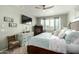 Inviting bedroom featuring a ceiling fan, stylish furnishings, a mounted TV, and calming color scheme at 11571 E Chevelon Trl, Gold Canyon, AZ 85118