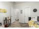 A bright bedroom features an open doorway to a hall, light walls, and wood-look flooring at 11571 E Chevelon Trl, Gold Canyon, AZ 85118