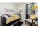 Bright bedroom with decorative pillows, stylish artwork, and light wood-look floors at 11571 E Chevelon Trl, Gold Canyon, AZ 85118
