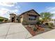 Inviting single-story home featuring desert landscaping, private drive and attractive architecture at 11571 E Chevelon Trl, Gold Canyon, AZ 85118