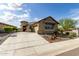 Welcoming single-story home with lush desert landscaping and charming architectural details at 11571 E Chevelon Trl, Gold Canyon, AZ 85118