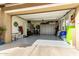 Spacious three car garage with ample storage and shelving at 11571 E Chevelon Trl, Gold Canyon, AZ 85118