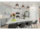 Modern kitchen with white cabinets, stainless steel appliances, and a large island with seating at 11571 E Chevelon Trl, Gold Canyon, AZ 85118