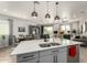 Stylish kitchen featuring a kitchen island with double sinks, modern lighting, and an open layout at 11571 E Chevelon Trl, Gold Canyon, AZ 85118