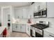 Well-lit kitchen featuring modern appliances, white cabinetry, and a stylish backsplash for a contemporary feel at 11571 E Chevelon Trl, Gold Canyon, AZ 85118