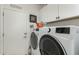 Laundry area features a modern white washer and dryer set and white cabinets at 11571 E Chevelon Trl, Gold Canyon, AZ 85118