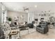 Bright, open living room featuring modern furniture, decor, and tile flooring adjacent to the kitchen at 11571 E Chevelon Trl, Gold Canyon, AZ 85118