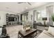 Cozy living room with a decorative display cabinet, plush seating and sliding doors to outdoor space at 11571 E Chevelon Trl, Gold Canyon, AZ 85118