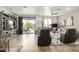 Relaxing living room features large windows offering natural light, tile flooring, and cozy furniture at 11571 E Chevelon Trl, Gold Canyon, AZ 85118