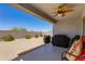The covered back patio contains a ceiling fan and space for seating at 11738 S 173Rd Ln, Goodyear, AZ 85338