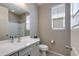 This is a bathroom featuring a vanity, toilet, and a window for natural light at 11738 S 173Rd Ln, Goodyear, AZ 85338