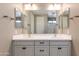 Bright bathroom features a double sink vanity with neutral cabinets and a large mirror at 11738 S 173Rd Ln, Goodyear, AZ 85338