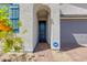 Welcoming front entrance with blue door, desert landscaping, and brick paver walkway at 11738 S 173Rd Ln, Goodyear, AZ 85338