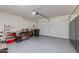 Large garage with epoxy floors, overhead door, and additional storage at 11738 S 173Rd Ln, Goodyear, AZ 85338
