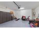 Spacious garage with epoxy floors, cabinet storage, and ample room for projects and vehicles at 11738 S 173Rd Ln, Goodyear, AZ 85338