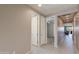 Neutral-toned hallway featuring light wood-look floors with open doorways to other rooms at 11738 S 173Rd Ln, Goodyear, AZ 85338