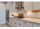 Kitchen details showcasing stainless steel hood, gas cooktop, and updated cabinets at 11738 S 173Rd Ln, Goodyear, AZ 85338