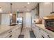 Bright, modern kitchen with stainless steel appliances, a large island, and beautiful light fixtures at 11738 S 173Rd Ln, Goodyear, AZ 85338