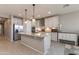 Bright kitchen with a large island, pendant lights, white cabinets and stainless steel appliances at 11738 S 173Rd Ln, Goodyear, AZ 85338