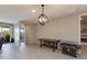 Spacious living area featuring neutral walls and tile flooring, with games at 11738 S 173Rd Ln, Goodyear, AZ 85338