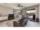 Bright living room showcasing wood-look tile flooring and sliding door to patio at 11738 S 173Rd Ln, Goodyear, AZ 85338