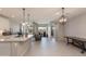 Inviting open-concept living space featuring pendant lighting, island, and backyard access at 11738 S 173Rd Ln, Goodyear, AZ 85338
