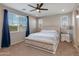 Bright main bedroom with natural light, a ceiling fan, and a comfortable bed at 11738 S 173Rd Ln, Goodyear, AZ 85338