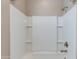 White tiled shower-tub combo with built-in shelving, clean and modern at 11738 S 173Rd Ln, Goodyear, AZ 85338