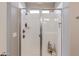 Modern walk-in shower featuring glass door and sleek fixtures at 11738 S 173Rd Ln, Goodyear, AZ 85338