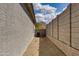 Side yard showing the gravel, stucco wall, and an air conditioning unit at 11738 S 173Rd Ln, Goodyear, AZ 85338