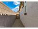 View of the side yard with a stucco wall, gravel, and view of distant mountains at 11738 S 173Rd Ln, Goodyear, AZ 85338