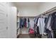 Organized walk-in closet with shelving and hanging rods for efficient storage at 11738 S 173Rd Ln, Goodyear, AZ 85338