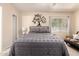 Well-lit bedroom features a ceiling fan, a large window, and stylish decorations at 125 S 56Th St # 100, Mesa, AZ 85206