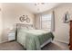 Bedroom features a comfortable bed, fan, and decorative wall art at 125 S 56Th St # 100, Mesa, AZ 85206
