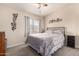 Bedroom features a comfortable bed, fan, and decorative wall art at 125 S 56Th St # 100, Mesa, AZ 85206