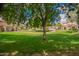 Exterior view of the neighborhood green space featuring manicured lawns and mature trees at 125 S 56Th St # 100, Mesa, AZ 85206