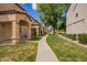 Exterior view of buildings and landscaped walking path through the well-maintained community at 125 S 56Th St # 100, Mesa, AZ 85206