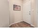 Entryway includes wood floors, a baseball print of the American flag, and a white door at 125 S 56Th St # 100, Mesa, AZ 85206