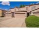 Desirable townhome showcases a tile roof, neutral stucco, private garage, and manicured shrubs at 125 S 56Th St # 100, Mesa, AZ 85206