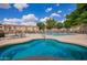 Relaxing hot tub with vibrant blue mosaic tile, seating, and nearby lounge chairs, perfect for unwinding and socializing at 125 S 56Th St # 100, Mesa, AZ 85206