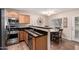 Modern kitchen with stainless steel appliances and wood cabinets with adjacent breakfast nook and access to backyard at 125 S 56Th St # 100, Mesa, AZ 85206