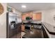Close up of kitchen featuring stainless steel appliances, wooden cabinets, and granite countertops at 125 S 56Th St # 100, Mesa, AZ 85206