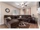Spacious living room with a large sectional sofa, ceiling fan, and attractive decor at 125 S 56Th St # 100, Mesa, AZ 85206