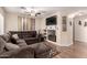 Comfortable living room includes a sectional, ceiling fan, mounted television, and built-in shelving at 125 S 56Th St # 100, Mesa, AZ 85206