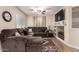 Cozy living room featuring a sectional sofa, ceiling fan, mounted TV, and custom shelving at 125 S 56Th St # 100, Mesa, AZ 85206