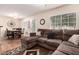 Open-concept living area with a sectional sofa, dining table, and ample natural light at 125 S 56Th St # 100, Mesa, AZ 85206